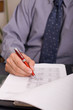 businessman filling in the tax form