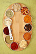 a variety of spices on a bamboo board