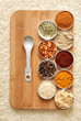 variety of spices on bamboo cutting board