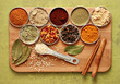 a variety of spices on a bamboo board