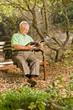 senior man reading on a bench senior man reading on a bench