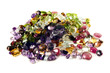 A large group of faceted gemstones on a white background