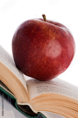 Photo: Apple red on open book inclined to reflect on the floor Apple red on open book inclined to reflect on the floor