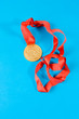 Gold medal with red ribbon