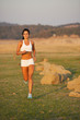 A woman running down a path at the beach A woman running down a path at the beach