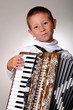 Young boy playing a 48 base accordion