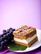 Delicious cream cake on the purple background.