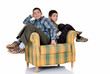 Two young happy smiling boys lean on against each others back