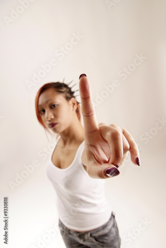 Photo: young woman holding up her index finger young woman holding up her index finger