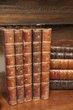 An image of stacks of antique books