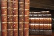 An image of stacks of antique books