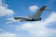Airplane over blue sky and white clouds