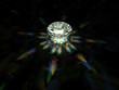 A sparkling brilliant cut diamond on dark background