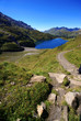 The lake in swiss mountains with hiking path and stones The lake in swiss mountains with hiking path and stones