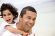 Father and son smiling and having fun at the beach