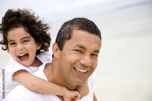 Photo: Father and son smiling and having fun at the beach Father and son smiling and having fun at the beach