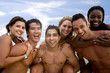 Happy group of friends smiling at the beach.