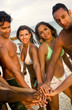 Group of friends united all smiling at the beach..
