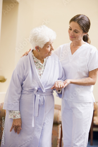 Photo: Nurse Helping Senior Woman To Walk Nurse Helping Senior Woman To Walk