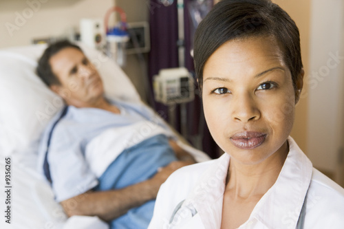 Photo: Doctor Looking Serious,Standing In Hospital Room Doctor Looking Serious,Standing In Hospital Room