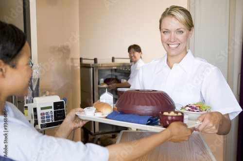 Photo: Nurse Serving A Patient A Meal In Her Bed Nurse Serving A Patient A Meal In Her Bed