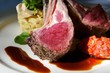 An image of gourmet lamb chops with garnishes