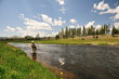 Active senior woman reeling in a trout Active senior woman reeling in a trout