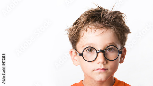 Photo: Face of cute guy in glasses isolated over white background Face of cute guy in glasses isolated over white background