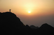 Man on top of the mountain during sunset.