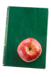 Apple red on a green book seen from above isolated
