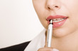 Image of silver pen near beautiful female mouth