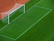 Empty goal gates on a green grass on a soccer stadium Empty goal gates on a green grass on a soccer stadium
