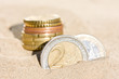 Euro coins in the sand