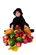 little girl in the witch costume with halloween harvest