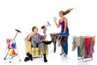 Young bossy man with megaphone,  woman ironing clothing