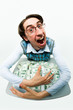 Portrait of greedy male raking in dollars and being glad Portrait of greedy male raking in dollars and being glad