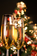 Blurred christmas tree and two champagne glasses