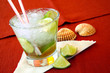 Brazilian caipirinha cocktail with limes and sea-shells
