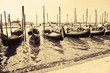 Gondolas at the wharf Venice Italy. Retro style photo.