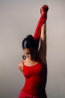 Artistic portrait of young hispanic dancer woman in red