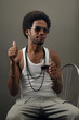 Photo: Portrait of young trendy latino man drinking with attitude Portrait of young trendy latino man drinking with attitude
