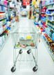 Closeup of a shopping trolley in aisle of supermarket.