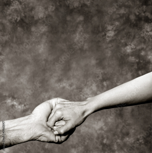 Holding hands on a grey background