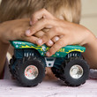 the little boy plays a toy car