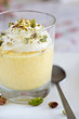 Delicious dessert with mango mousse and pistachio nuts Delicious dessert with mango mousse and pistachio nuts