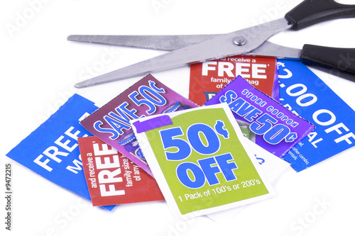 Photo: clipping coupons to save money at the grocery store clipping coupons to save money at the grocery store