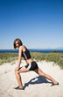 A caucasian girl stretching before exercise on the beach