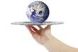 Hand holding a silver tray with the world on it Hand holding a silver tray with the world on it