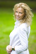 smiling blonde woman in park