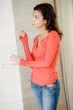 Foto: A young woman looking in her wardrobe A young woman looking in her wardrobe
